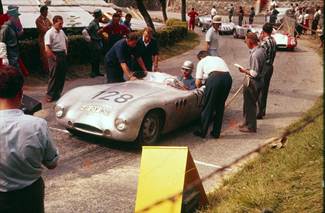 Club member Hans Herrmann at the wheel of his Borgward 1500 . Standing behind the car in the white helmet is his rival Wolfgang von Trips who was driving a Porsche