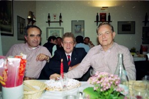 Phil Hill, right, with Jean Sage, left and Graham Gauld in the San Donnino restaurant with the birthday candle. (Photo Jane Wallis-Hosken)