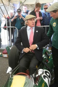 Jackie Stewart takes off his blazer before getting into the ex-Jim Clark Lotus 25 now owned by Nick Fennell, right