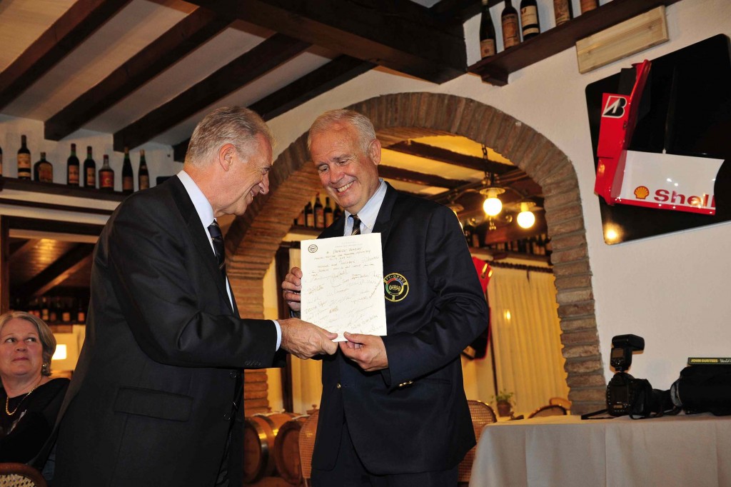 Patrick Tambay, presents an autographed menu to Piero Ferrari in the Cavallino Restaurant opposite the Ferrari factory. (Photo Peter Meierhofer)