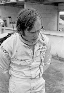 Chris Amon reflects in the Paddock.
