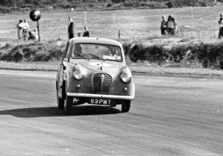 Graham Hill sweeps round Club corner at Silverstone in the 1958 saloon car race support to the British Grand Prix