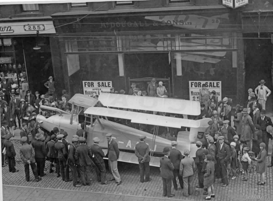 An exciting day in Glasgow’s Sauchiehall Street when this Blackburn Bluebird aeroplane was delivered to Bill Slack’s car and aeroplane showroom in the centre of town