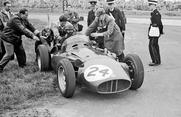Tony Brooks in the BRM P26  gets a push start from driver Mike Anthony at the 1956 British Grand Prix when his throttle cable broke