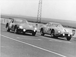 Claude in Aston Matrin DB4 Zagato (1) just beats the Ferrari 250 GTO of Sylvain Garant at Reims during a race on the Route du Nord event in 1964.