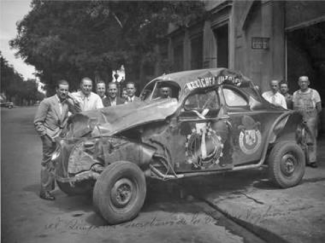 Benedicto Campos, extreme left with his wrecked Dodge after a roll-over
