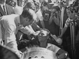 Paul Frere being congratulated by Stirling Moss for winning the non-Champinship South African Grand Prix in 1960 with a Cooper-Climax. Stirling finished second (Photo Rob Young Archive)