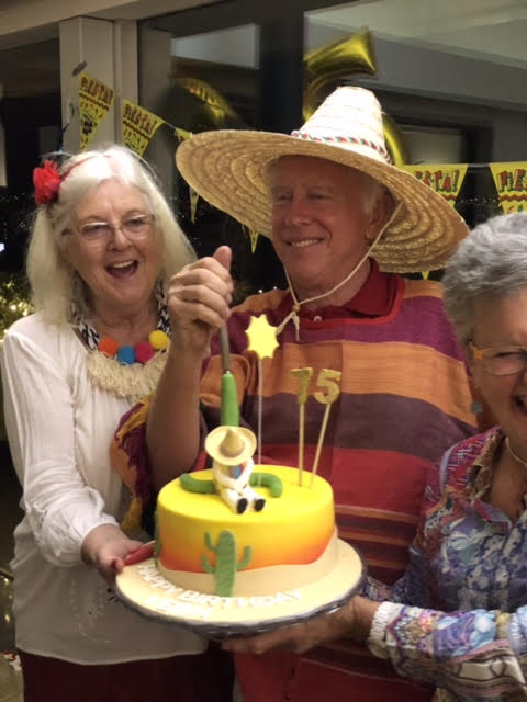 Vern Schuppan celebrating with his wife Jenny and appropriate head gear.