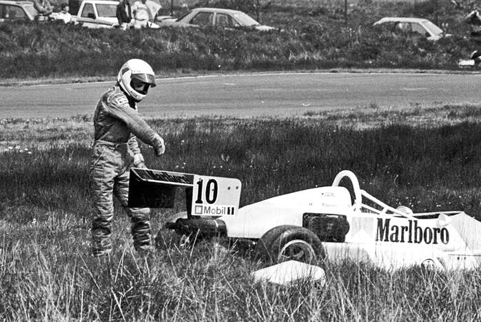 Mika Hakkinen throws his glove in frustration at his Formula Vauxhall Lotus after going off the road at Knockhill in 1988