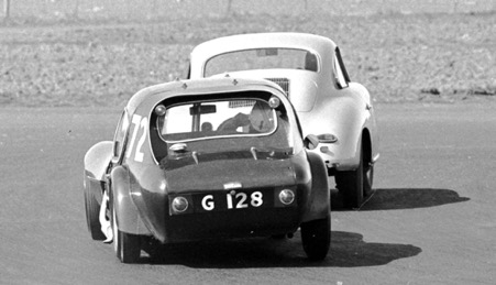 Jackie Stewart in action with the Marcos chasing Gordon Durham’s Porsche Carrera in 1961. The Marcos is now owned by Matteo Panini
