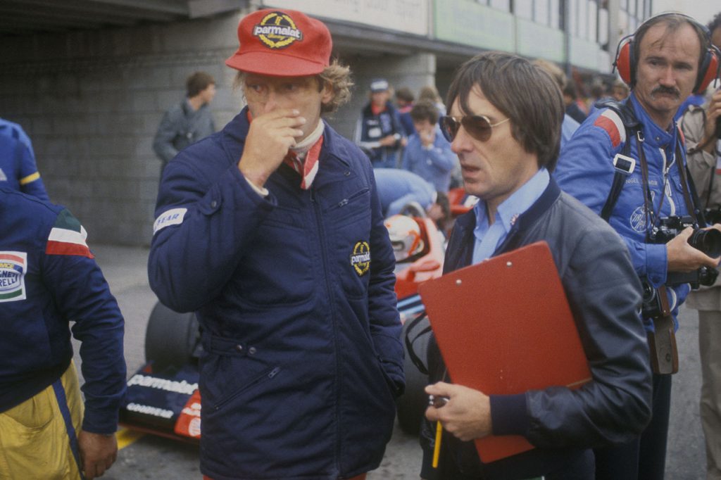 Niki Lauda and Brabham-Alfa Romeo team principal Bernie Ecclestone in the pits during practice for the 1978 Dutch Grand Prix in Zandvoort. Behind them are John Watson (in car) and photographer Nigel Snowdon. Photo: Grand Prix Photo
