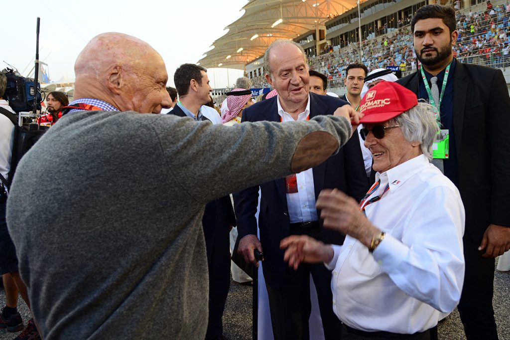 Watched by King Juan Carlos of Spain, Niki Lauda puts his cap on Bernie Ecclestone before the 2015 Bahrain Grand Prix. Photo: Grand Prix Photo