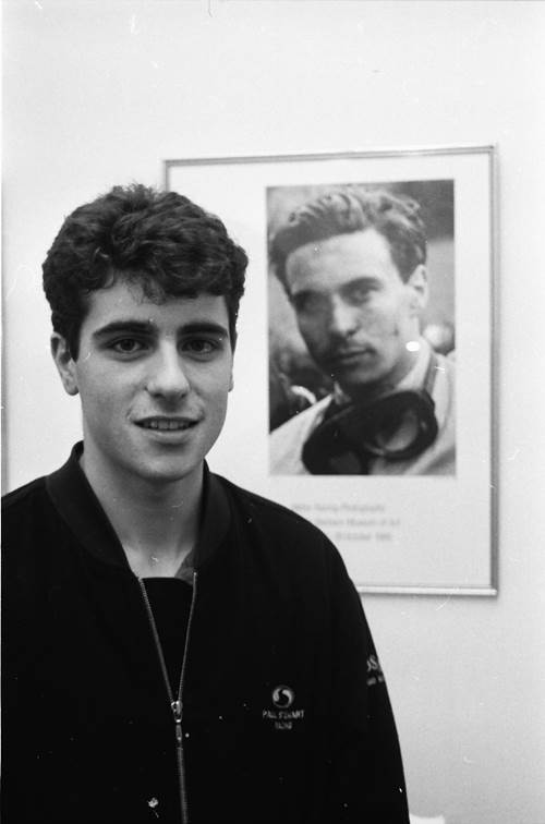 Black and white photo of a young man called Dario Franchitti in front of a photo os Formula 1 racing legend Jim Clark