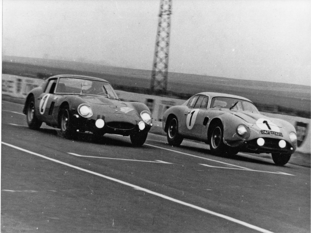 Claude Le Guezec , right, in the Aston Martin DB4 Zagato beats a Ferrari GTO to the line in France