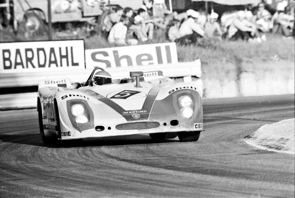 Black and white photos of Helmut Marko in a Porsch 908/02 driving in South Africa