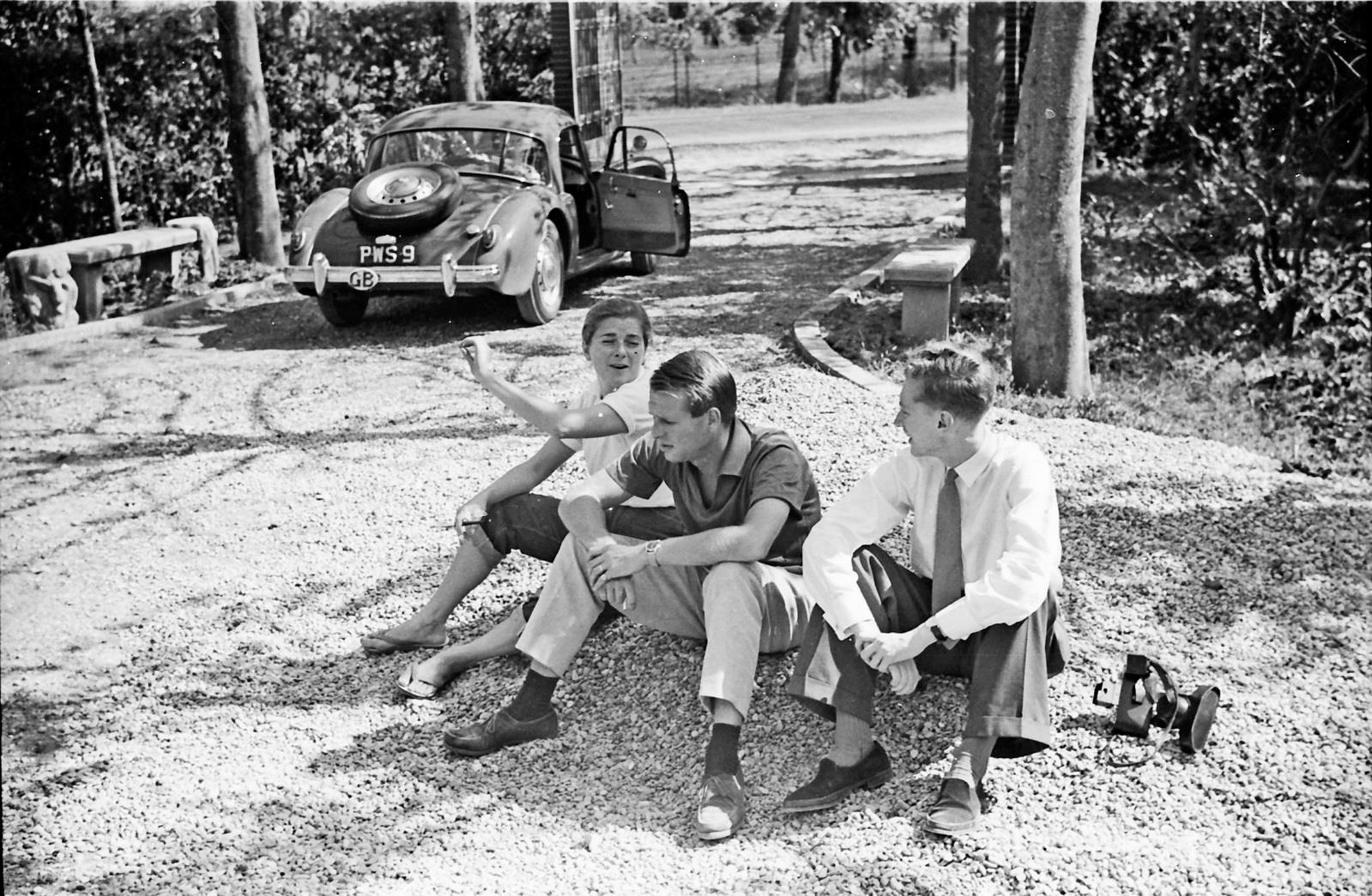 Racing driver Peter Collins and his wife Louise, left, with Graham Gauld photographed in 1957 sitting in the drive of the Villa Rosa in Maranello that was owned by Enzo Ferrari and loaned to Peter when he lived there.